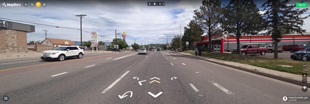 Mapillary image showing where 8th St Construction is planned, depicting current condition with narrow sidewalk, on street bike lane and wide vehicle lanes